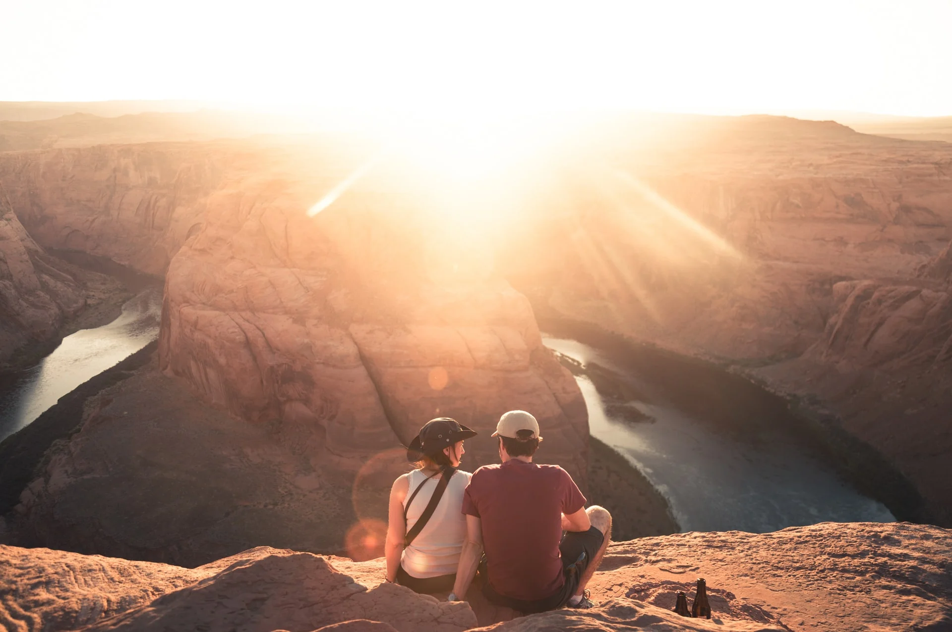 A couple watch the sunset on a hike - get ideas for the most romantic gifts for hikers and campers