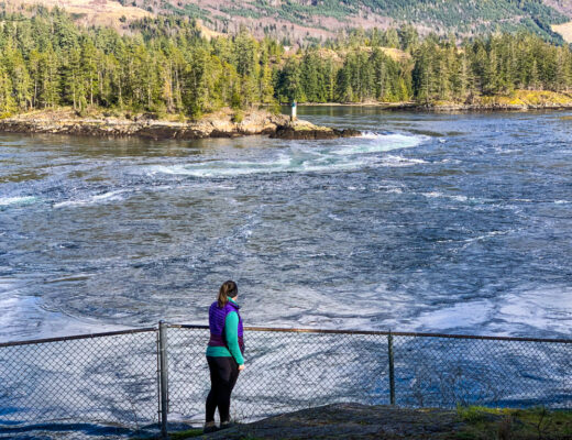 A woman watches the rapids at Skookumchuck Narrows on the Sunshine Coast, BC