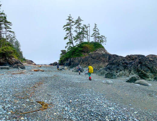 Hikers on the beach near Cape Sutil on the North Coast Trail. Day 3 of the North Coast Trail itinerary