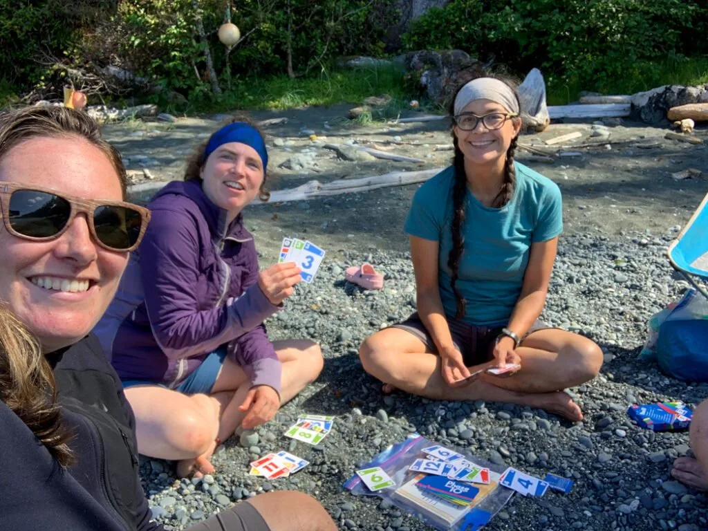 Hikers playing cards on the North Coast Trail