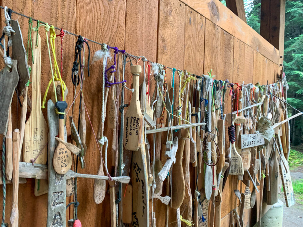 Carved paddles hanging on a line at Isaac Lake