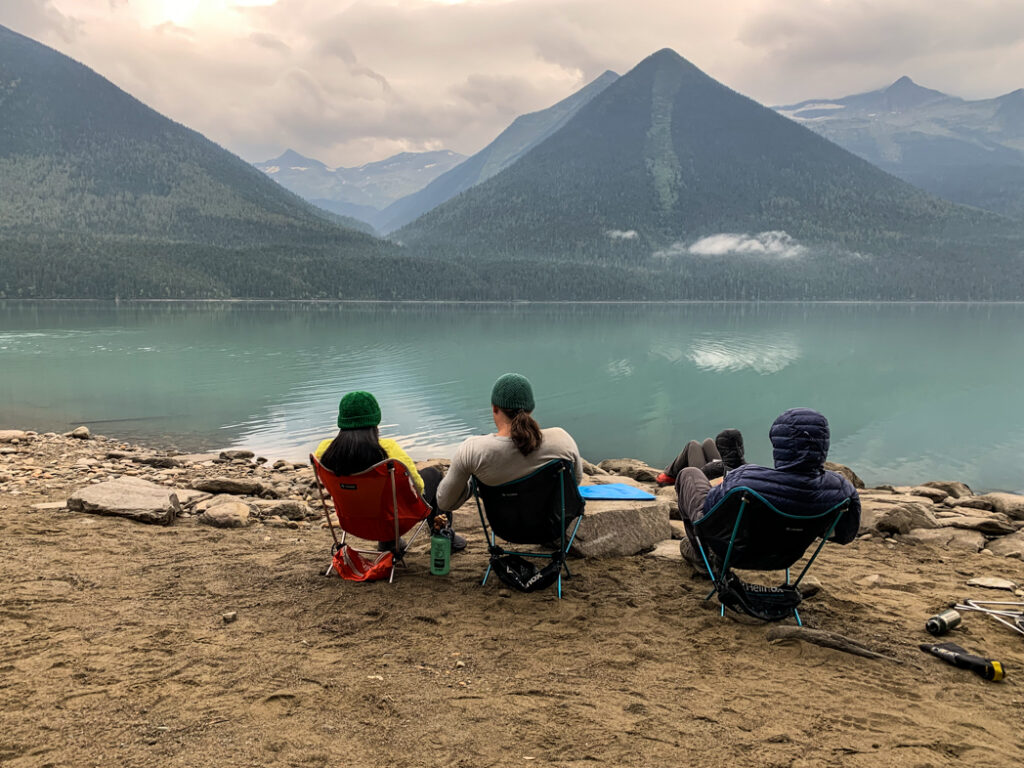 People sitting in camp chairs on the Bowron Lakes canoe chain