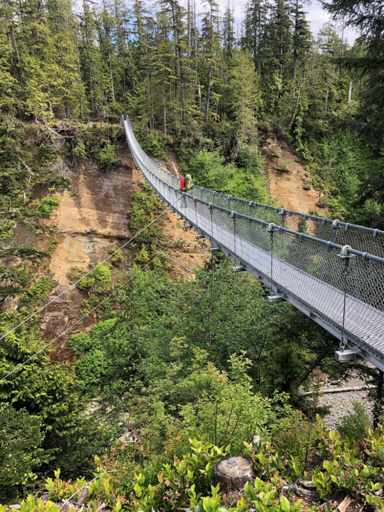 A hiker on the new Logan Creek Suspension Bridge on the West Coast Trail