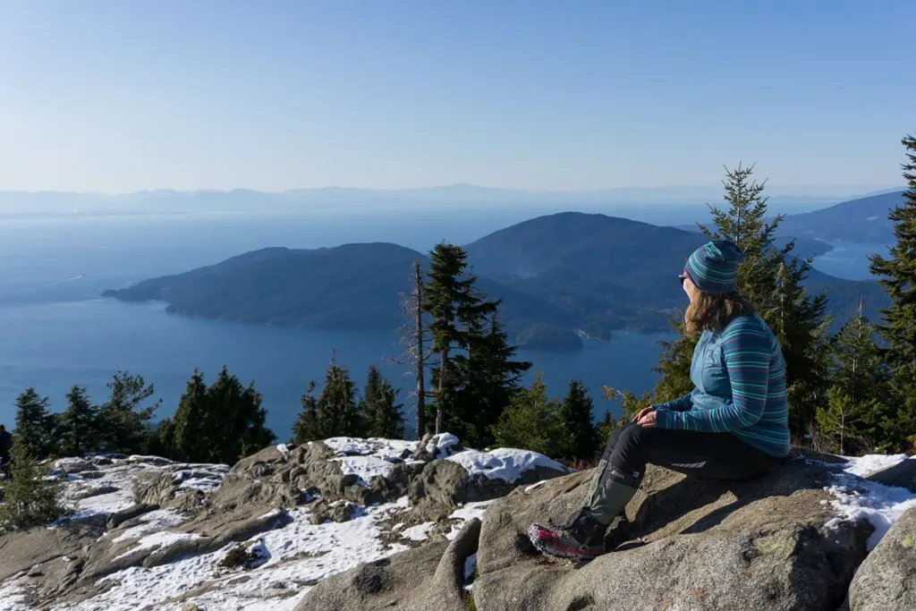 A woman wearing gaiters on a winter hike