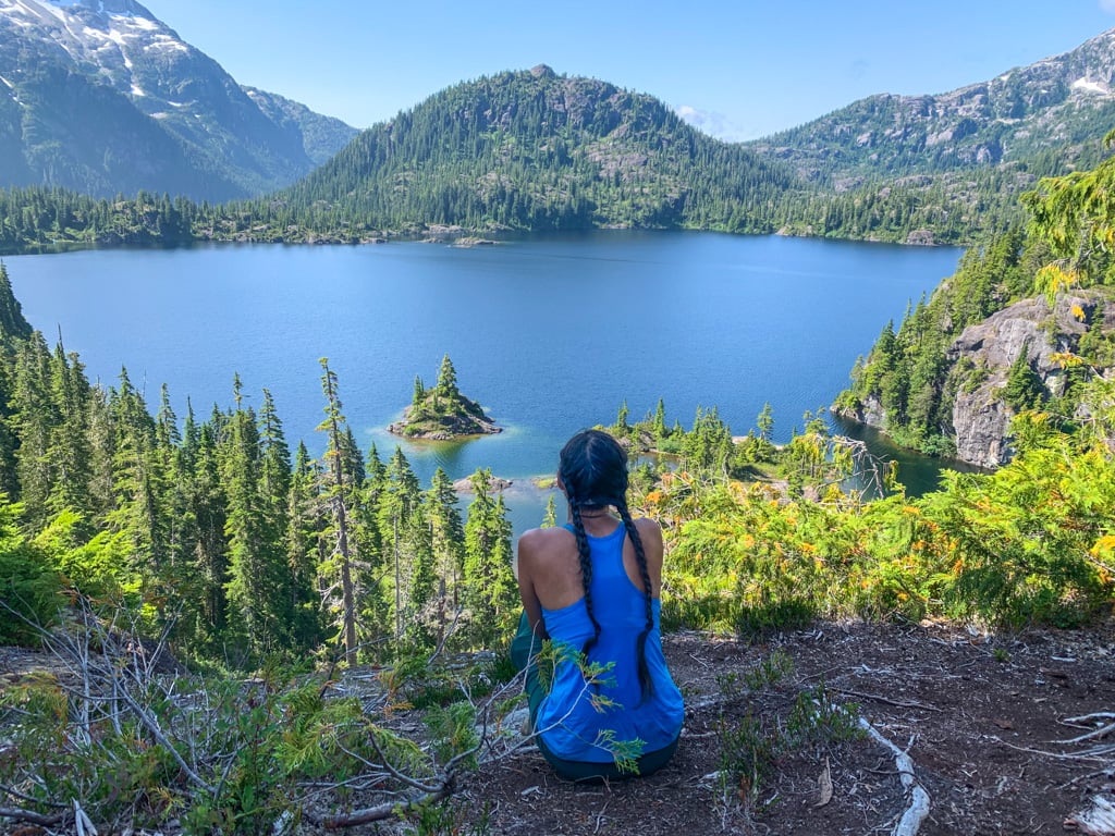 A hiker enjoys the view of Bedwell Lake, one of the best backpacking trips on Vancouver Island