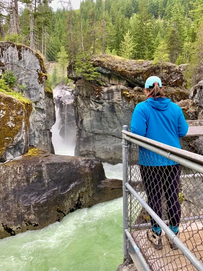 a woman looks at Nairn Falls near Pemberton