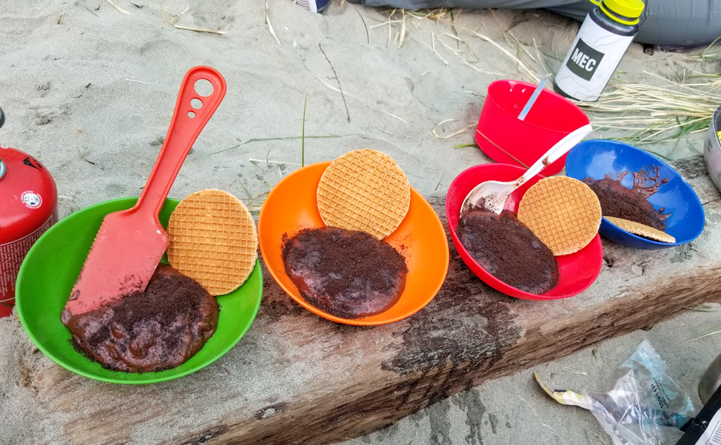 Four bowls of backpacking pudding at camp