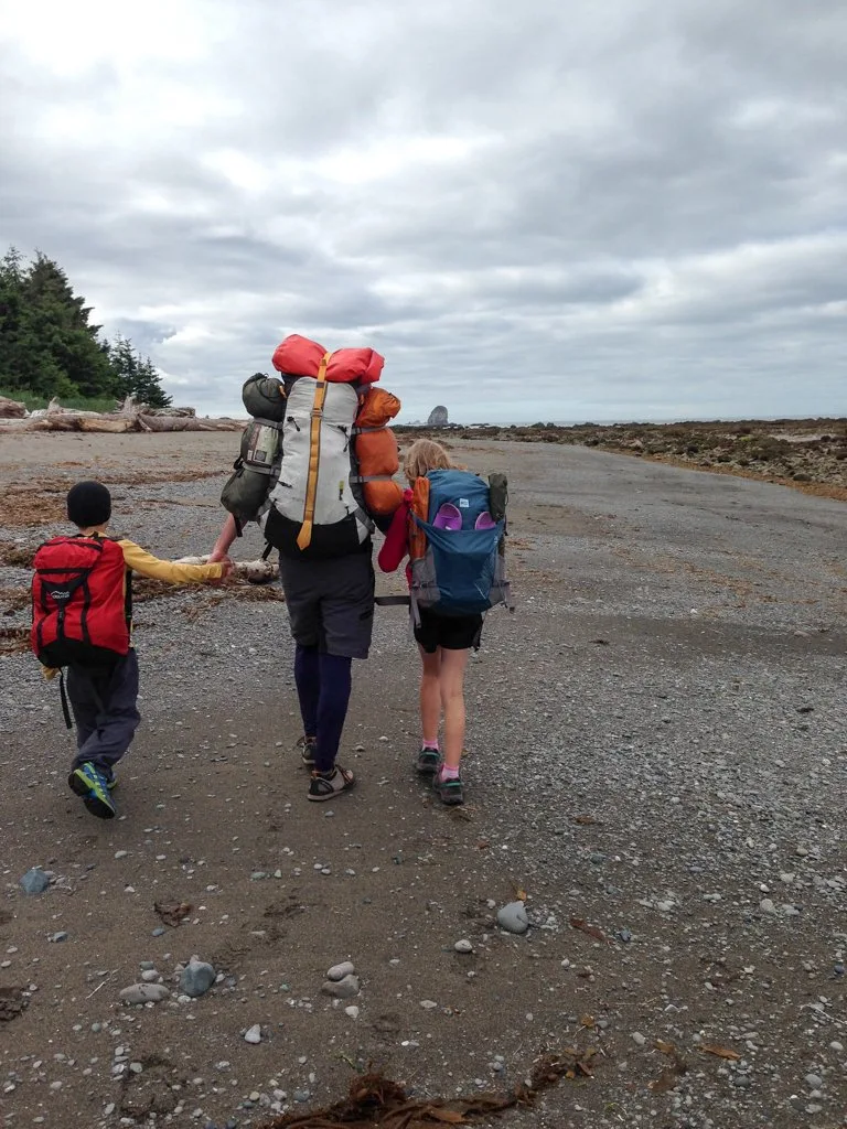 A family backpacking on the Ozette Loop in Olympic National Park