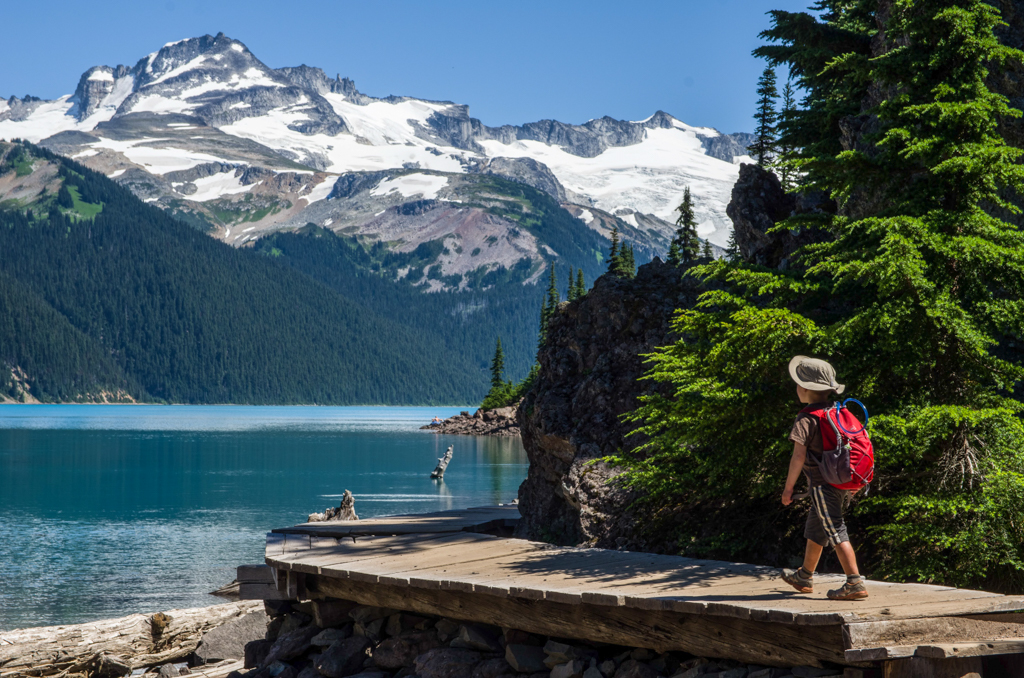 A little boy with a backpack hikes at Garibaldi Lake