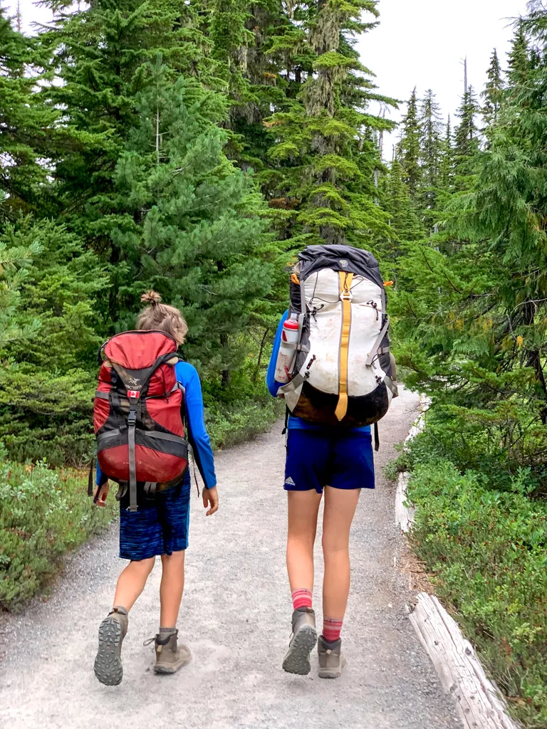 Tweens carrying their own backpacking packs 