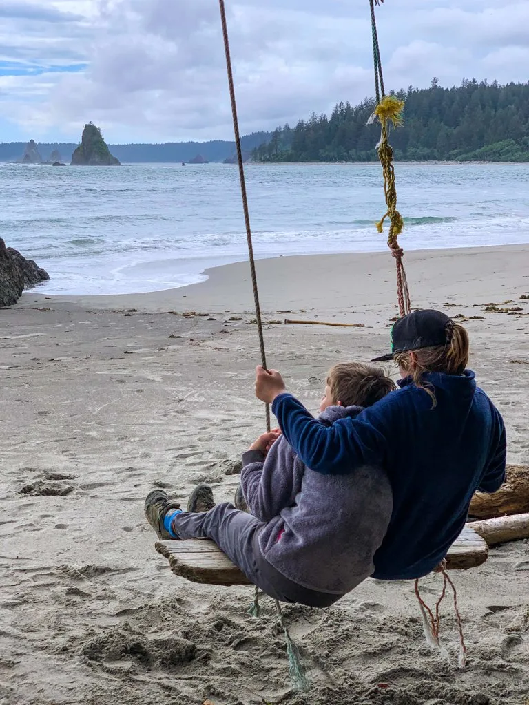 Two kids on a swing at Toleak Point in Olympic National Park