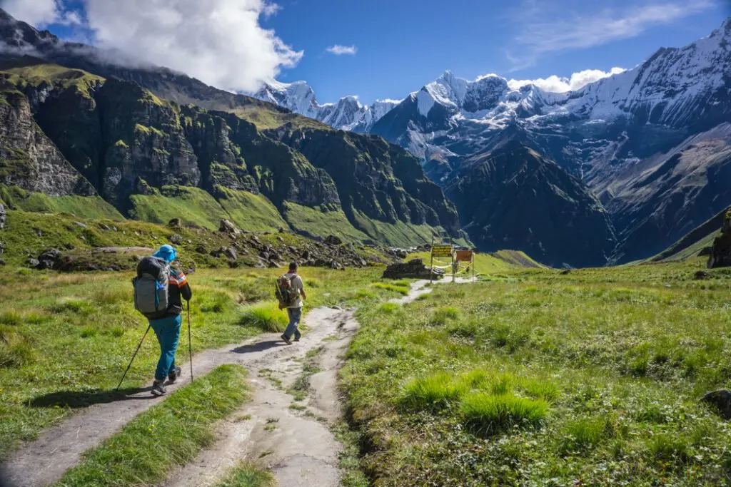 Trekkers near Annapurna Base Camp. Want to know what the difference is between hiking, trekking, and backpacking? Get the answer in this glossary of hiking terms.