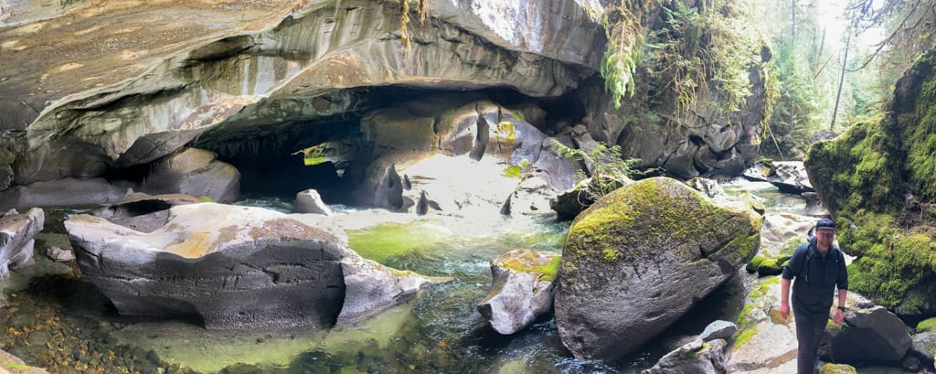 Panoramic view of Atluck Creek Canyon and the entrance to the main cave at Little Huson Caves.