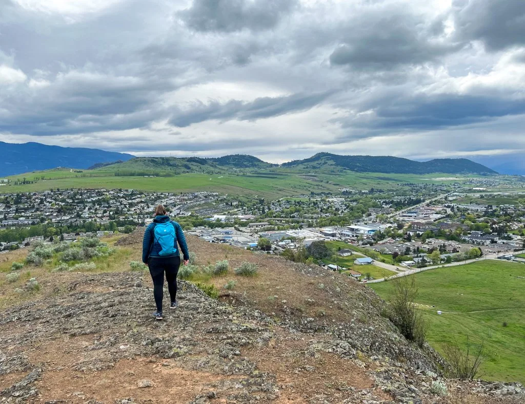 A hiker stands at the Rocky Ridge Viewpoint on the Grey Canal Trail, one of the best things to do in Vernon