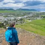 A hiker admires the view of Vernon BC while wearing the Eddie Bauer MicroTherm Down Hoody