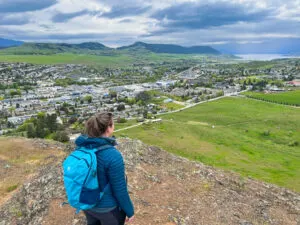 A hiker admires the view of Vernon BC while wearing the Eddie Bauer MicroTherm Down Hoody
