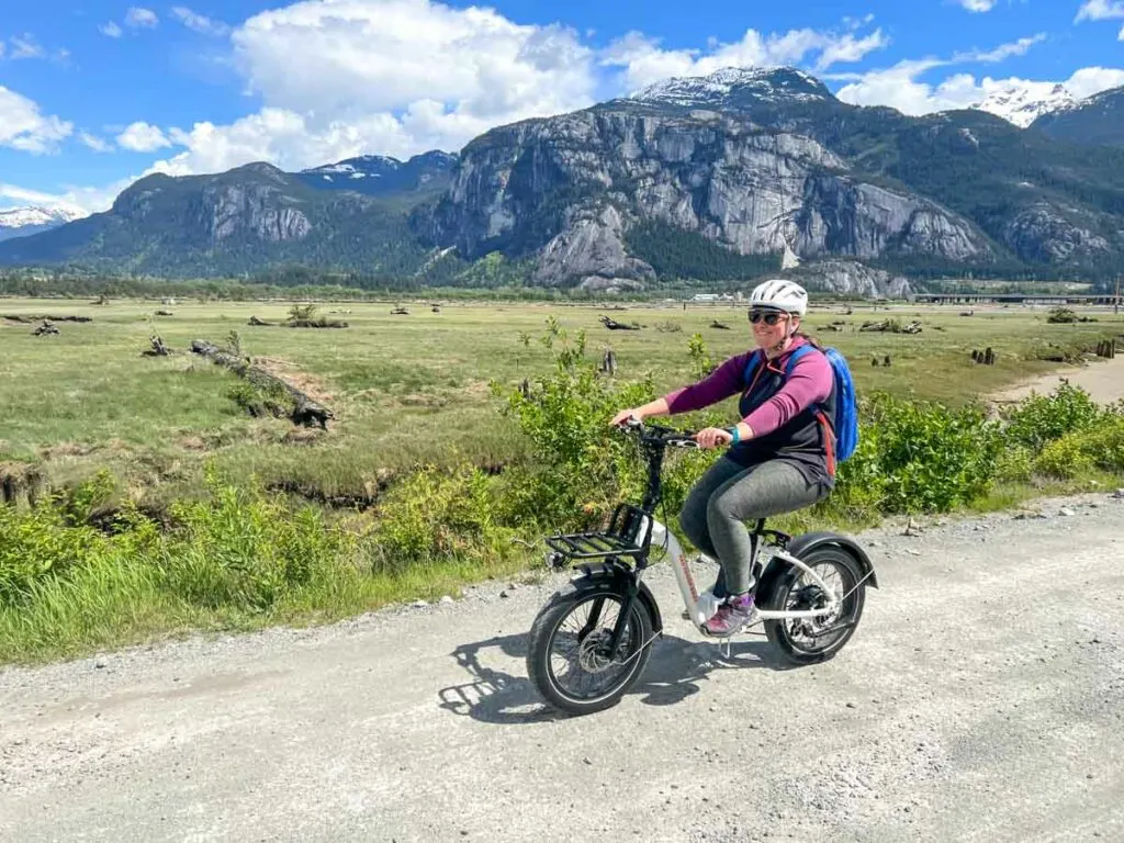 A woman rides the Rad Power RadMini Step-Thru electric bike in Squamish, BC