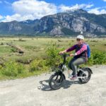 A woman rides the Rad Power RadMini Step-Thru electric bike in Squamish, BC