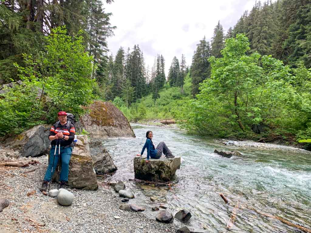 Two hikers take a break next to Drinkwater Creek