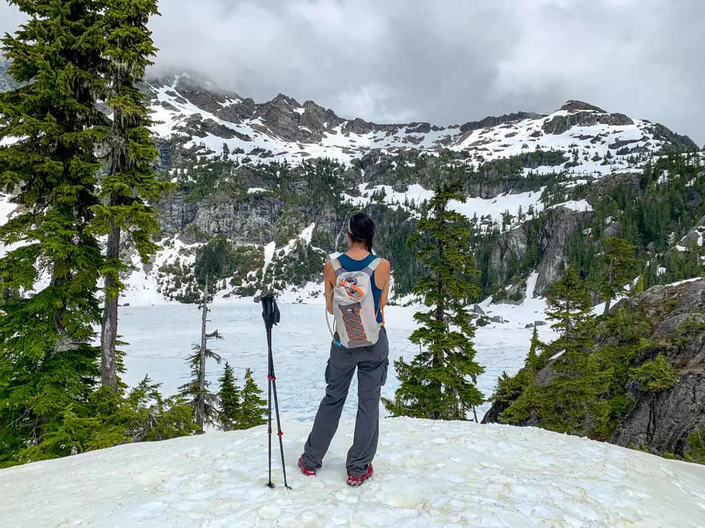 A hiker looks down on frozen Love Lake
