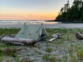 An ultralight tent on the beach at sunset on the Tatchu Trail, a wilderness backpacking trip on the Tatchu Peninsula on the west side of Vancouver Island, BC