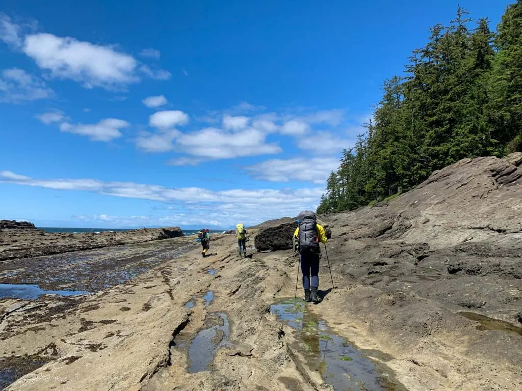 Hiking on the sandstone shelf at low tide on the Tatchu Peninsula