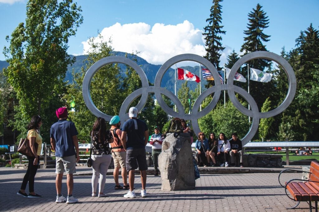 Tourists take photos with the Olympic Rings in Whistler Village - one of the best free things to do in Whistler