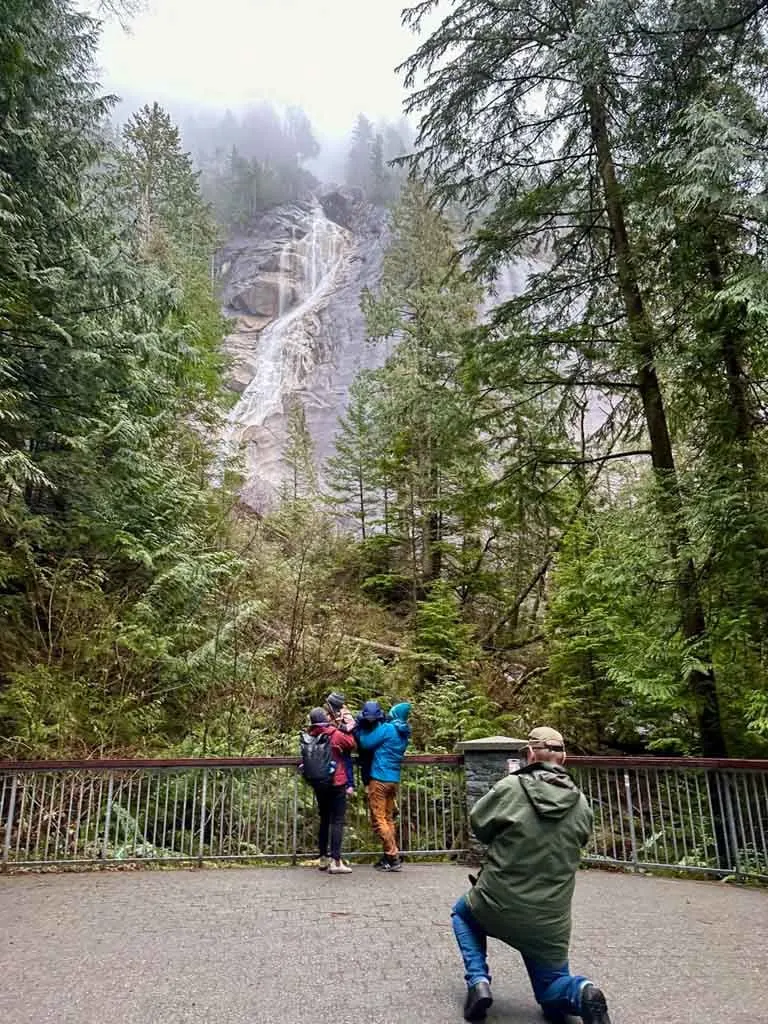 A family takes a photo at Shannon Falls