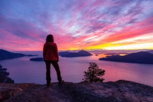 A hiker enjoys sunset at Tunnel Bluffs