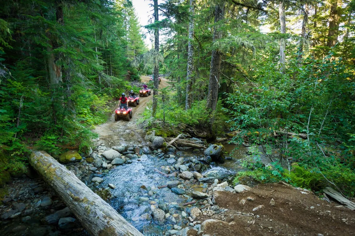 Crossing a creek on an ATV tour in Whistler