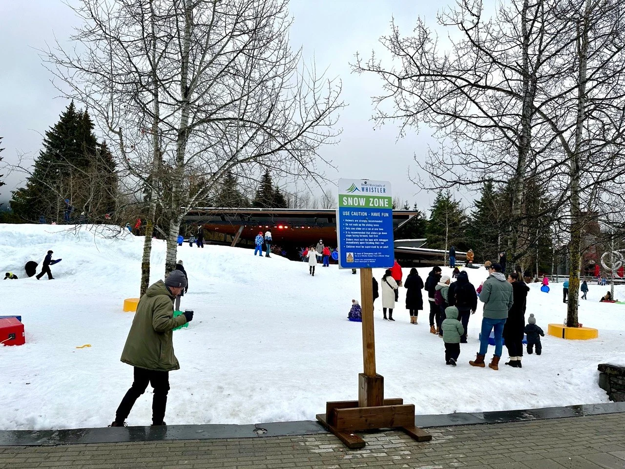 People play in the snow at the Whistler Village Snow play zone