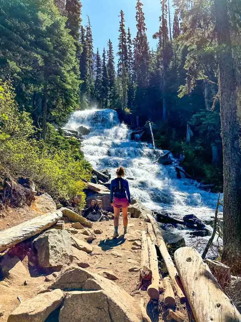 A hiker stands in front of Holloway Falls