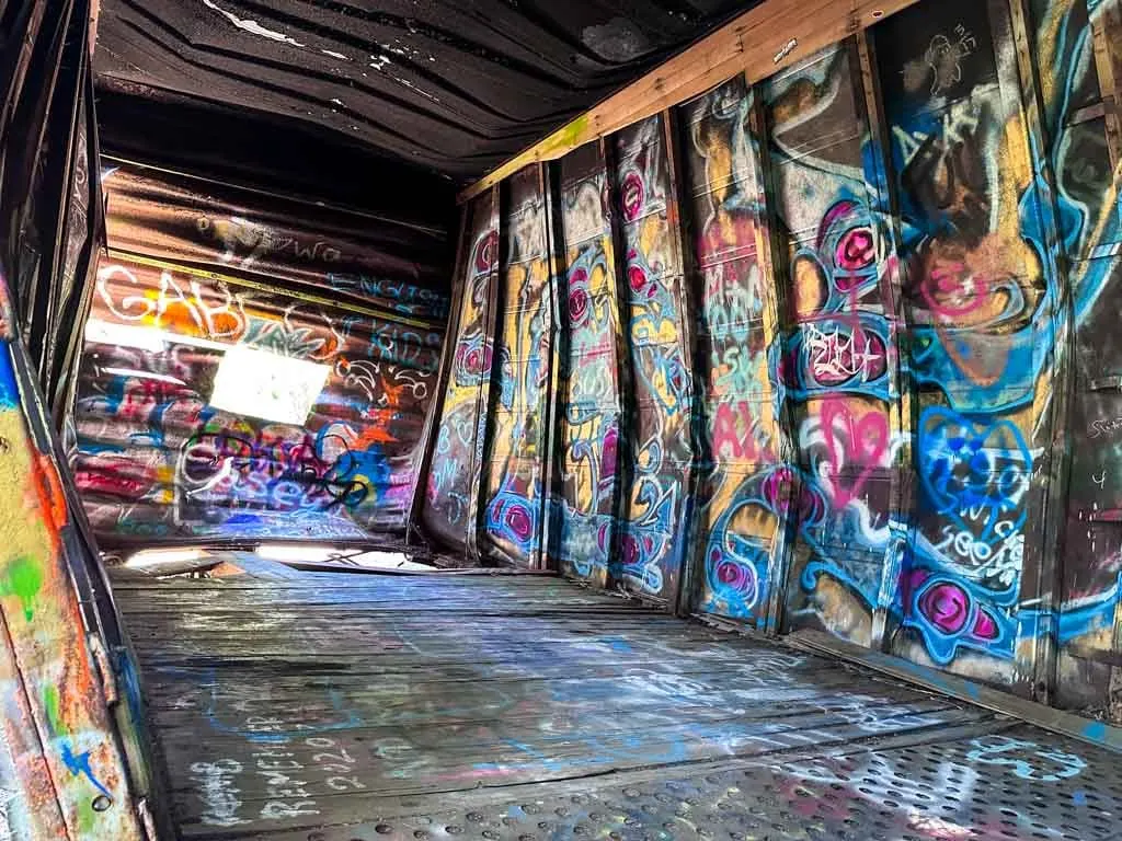 Inside an abandoned train car covered in graffiti