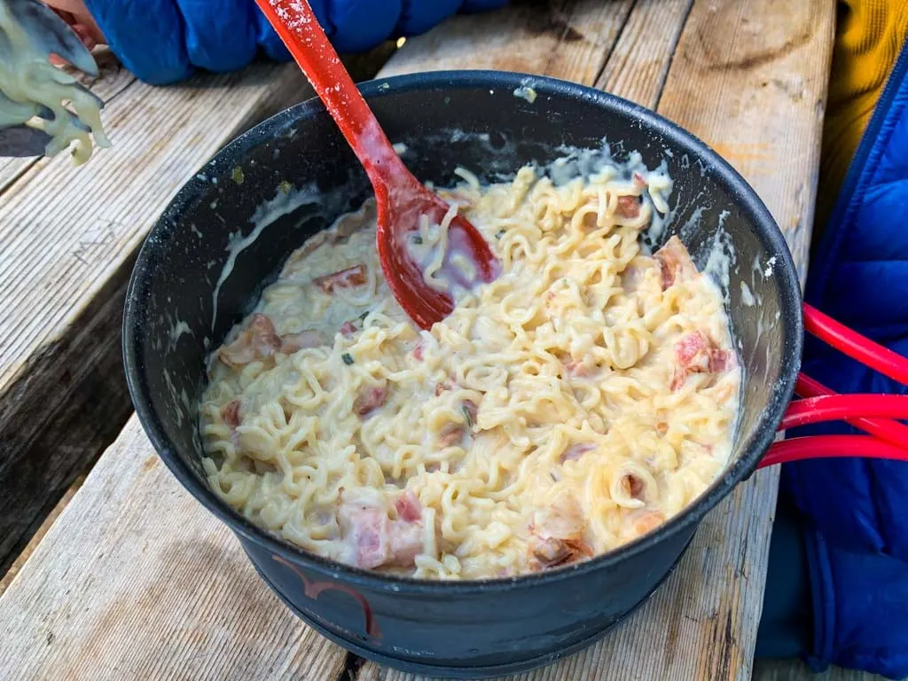 A big pot of pasta carbonara on a backpacking trip