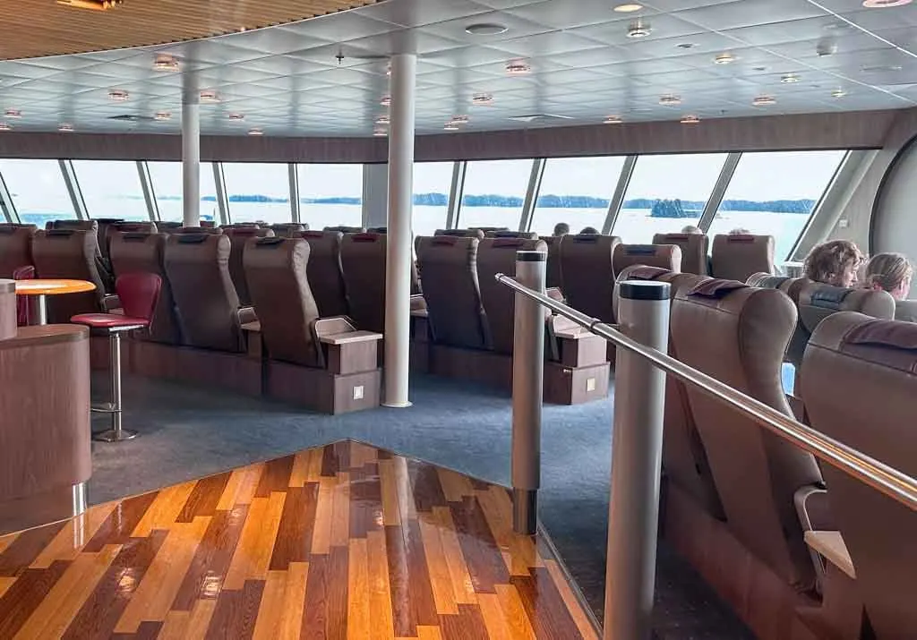 The interior of the Aurora Lounge on the Northern Expedition ferry on the Inside Passage Route. It has reclining seats and huge windows. 