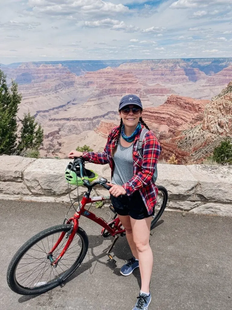 A woman poses with her bike on Hermit Road