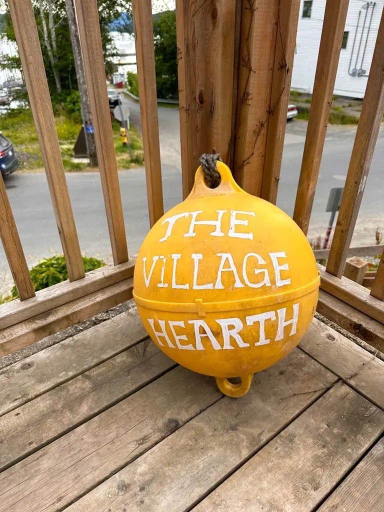 Sign on a buoy at The Village Hearth Cafe in Daajing Giids, BC