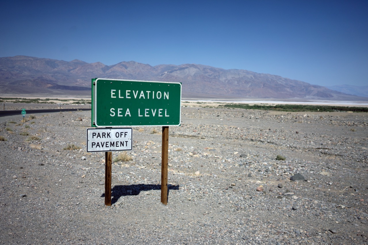 A sign reading "Elevation Sea Level" in Death Valley