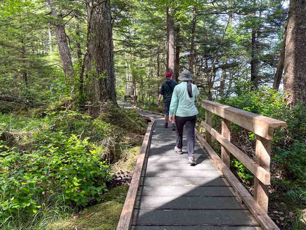 Two hikers walk along the wheelchair accessible boardwalk at Tow Hill in Naikoon Provincial Park