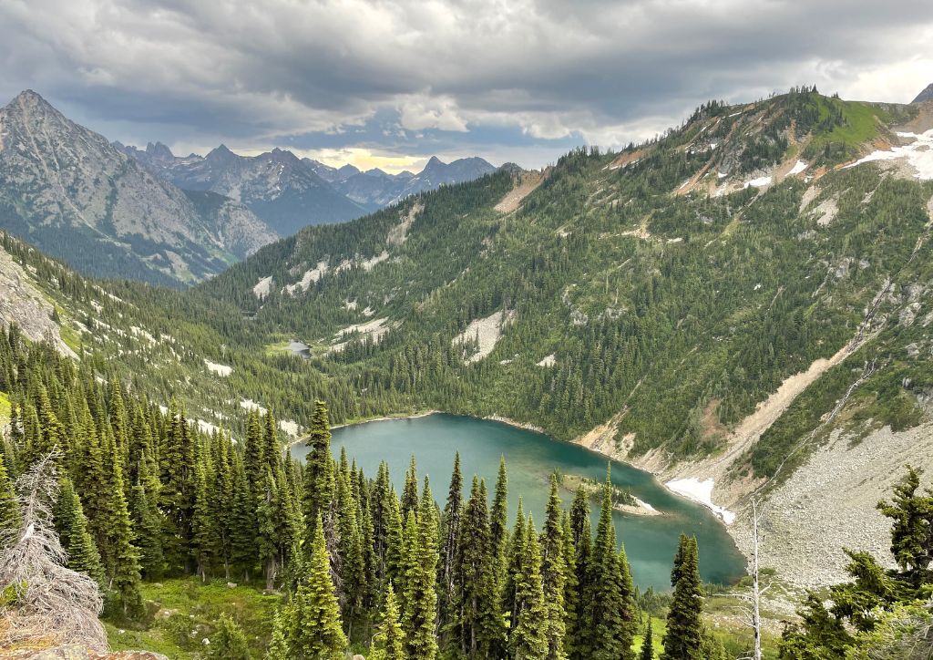 An alpine lake nestled between mountains in North Cascades National Park. 