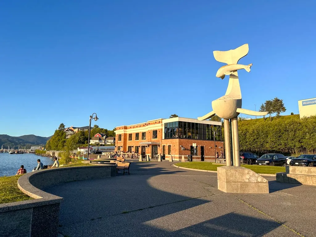 The whale statue and Wheelhouse Brewing inside the old brick rail station at Waterfront Park in Prince Rupert