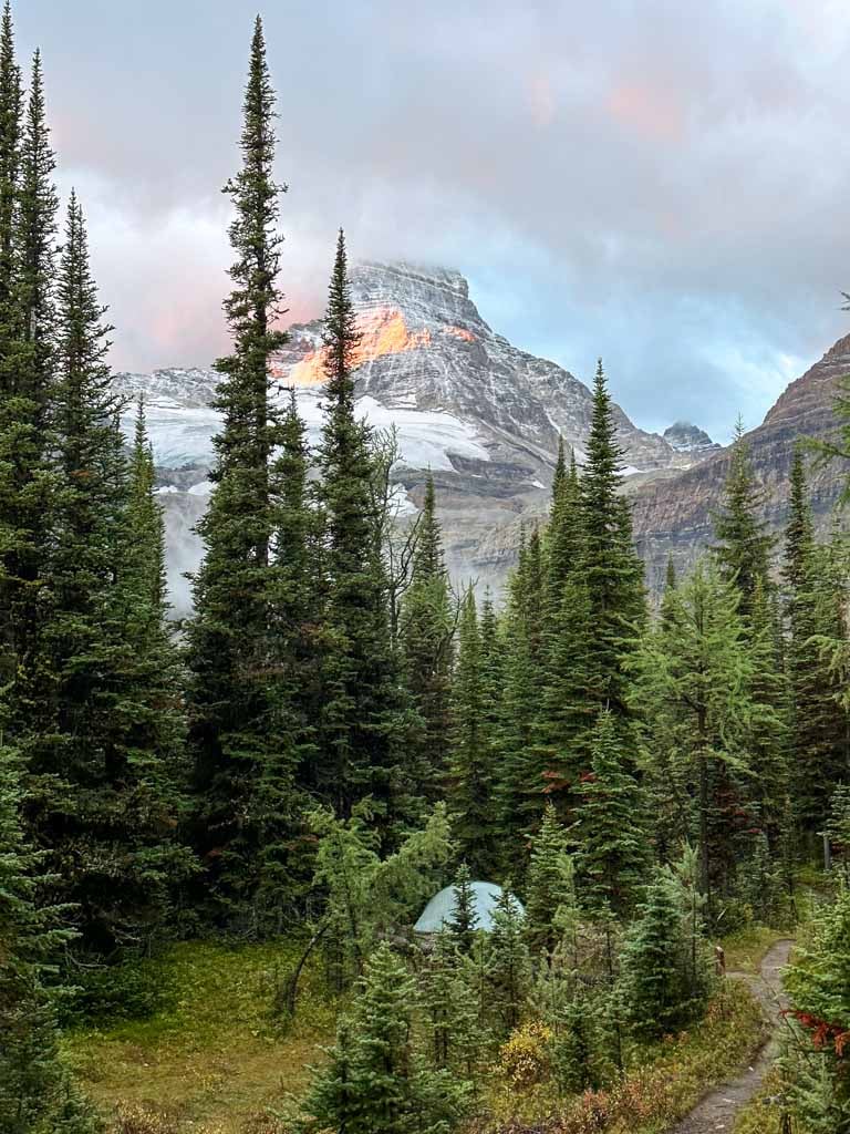 A tent in the Lake Magog Campground with Mount Assiniboine