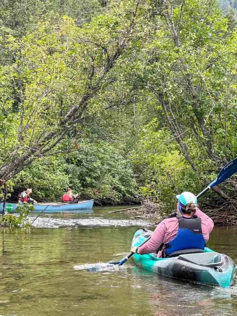 A woman kayaks on the river of Golden Dreams