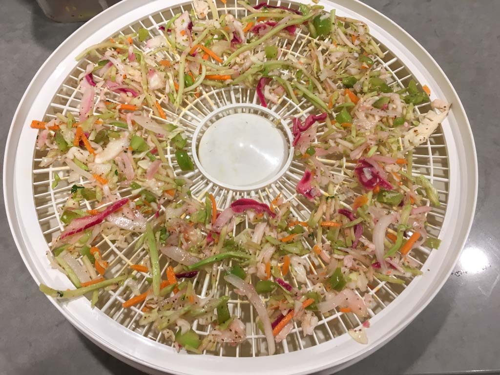 Coleslaw on a dehydrator tray ready to be dried. 
