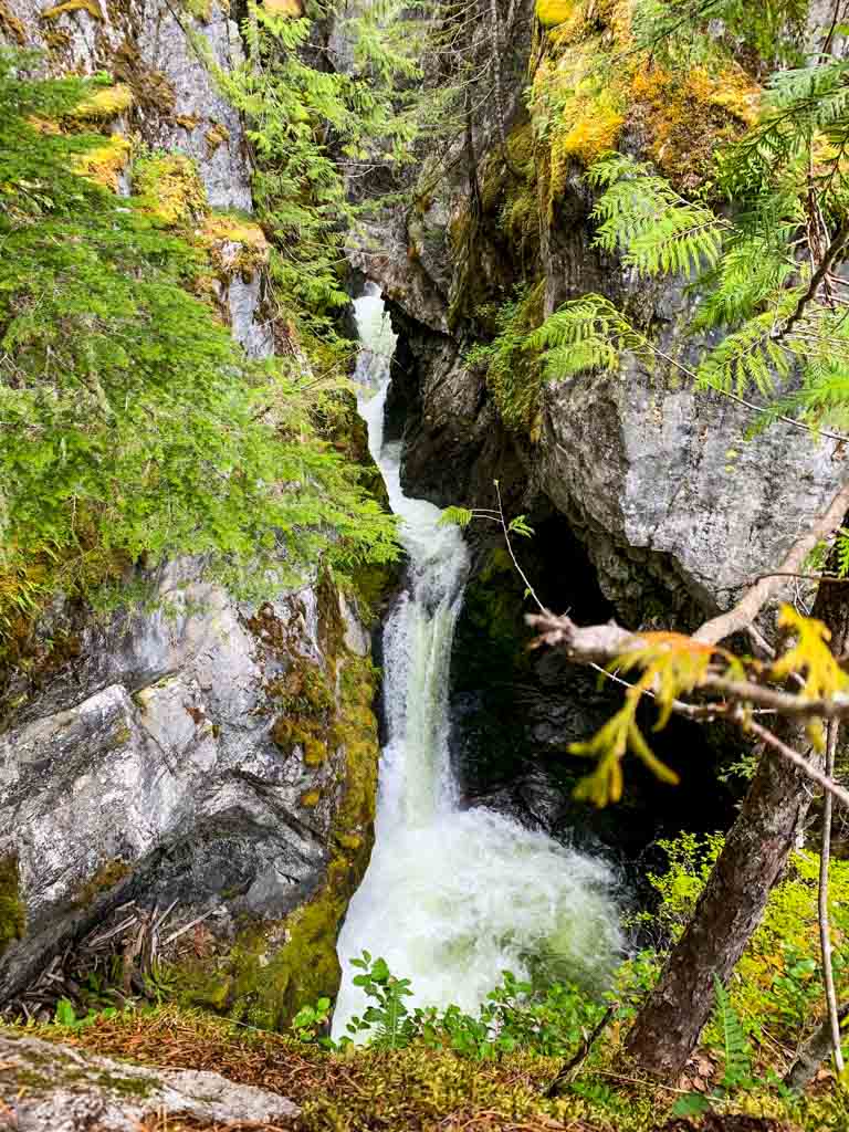 View of the upper falls rushing through a rock canyon at High Falls Creek in Squamish