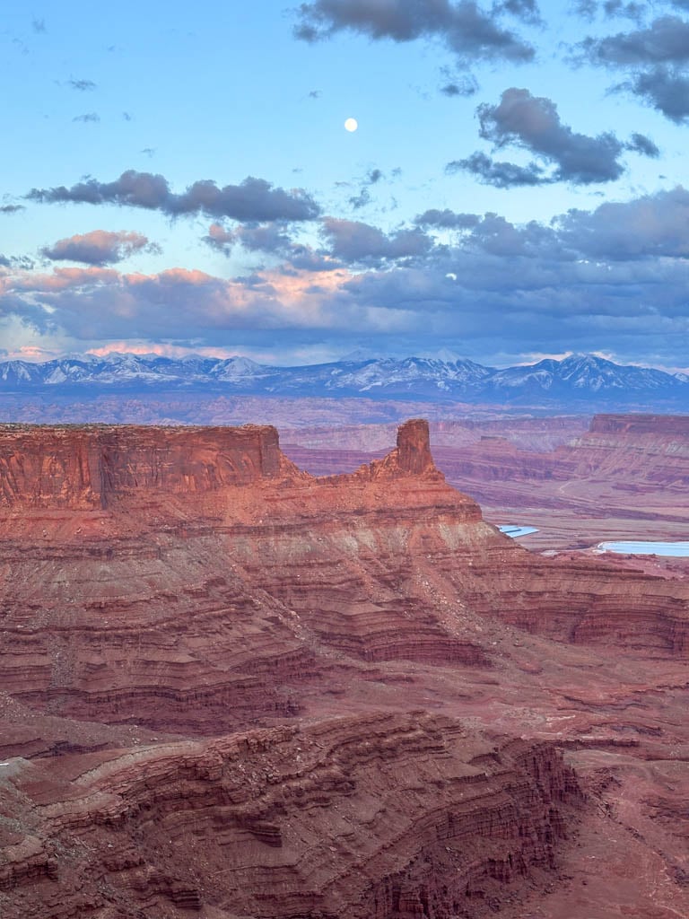 Full moon at sunset over rock formations at Dead Horse Point State Park near Moab