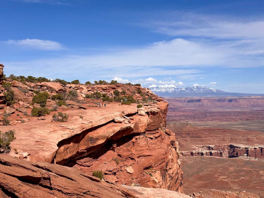 Hikers walk along an easy trail at Grand View Point in Canyonlands National Park near Moab