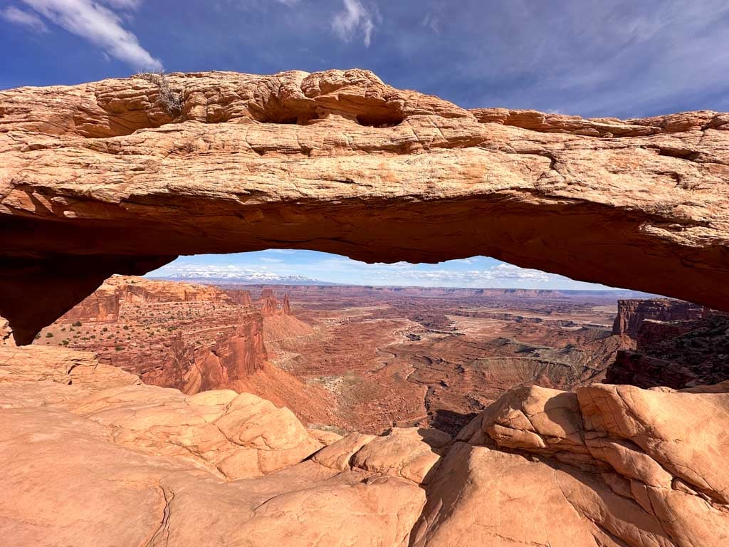 Looking under Mesa Arch into the Colorado River Canyon in Canyonlands National Park