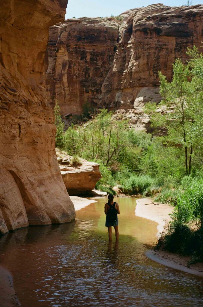 A woman stands in Mill Creek near Moab