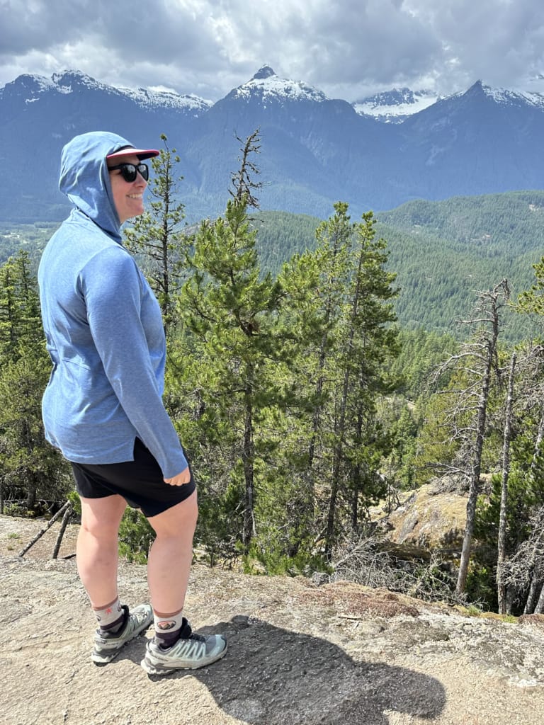 Wearing a woman wearing the Outdoor Research ActiveIce Spectrum Sun Hoodie on a hike